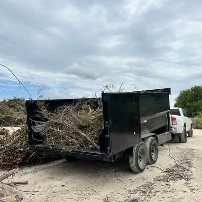 Mako utility trailer fully loaded with dried brush and branches from a Texas yard cleanup